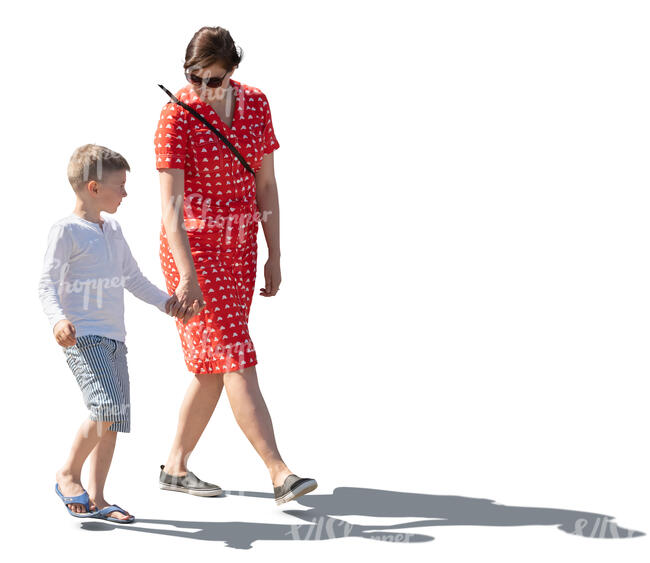 backlit image of a a mother and son walking