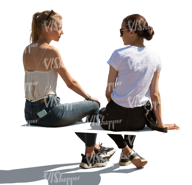 two cut out  women sitting and talking seen from behind