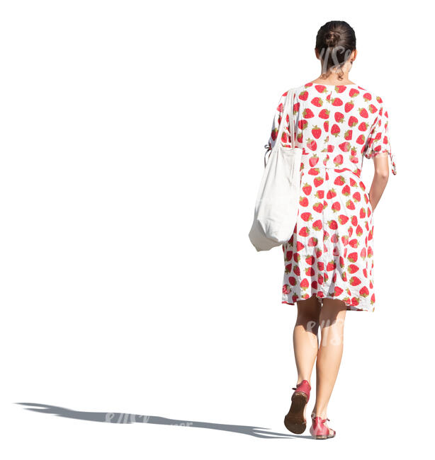 cut out woman in a strawberry patterned summer dress walking