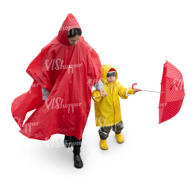 cut out woman with her little son walking in the rain seen from above