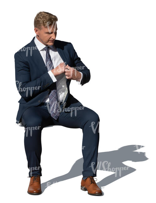 cut out man in a suit sitting outside in the sunlight