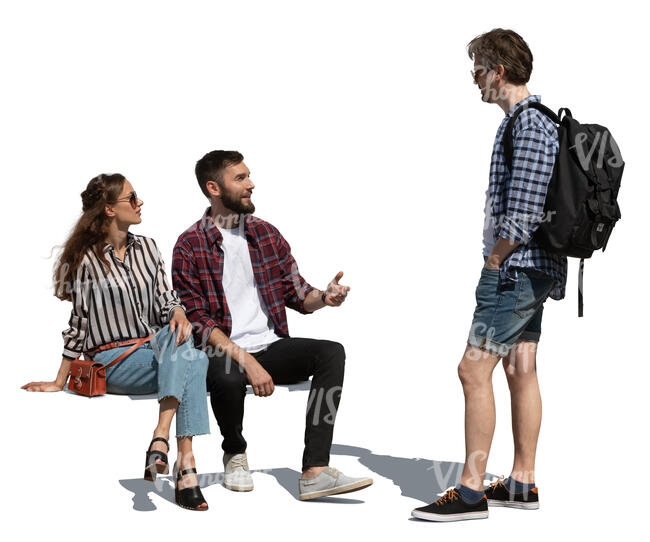 two cut out people sitting and talking to a man standing in front of them