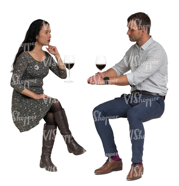 cut out man and woman sitting in a restaurant and drinking wine