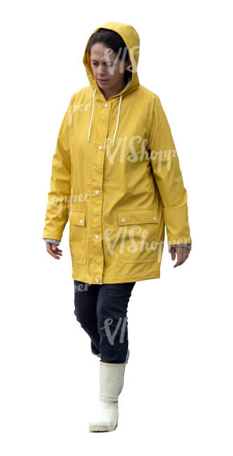 cut out woman in a yellow raincoat walking