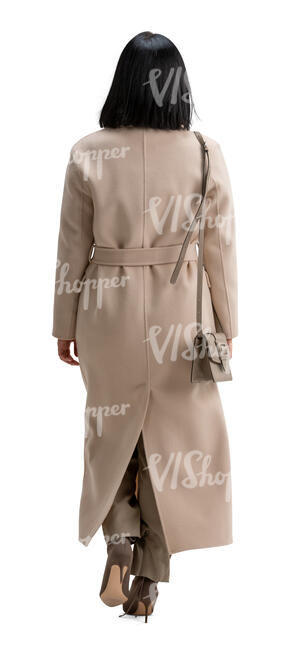 cut out woman in a long brown overcoat walking