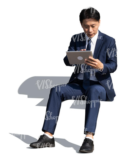 cut out asian  businessman sitting and working with tablet