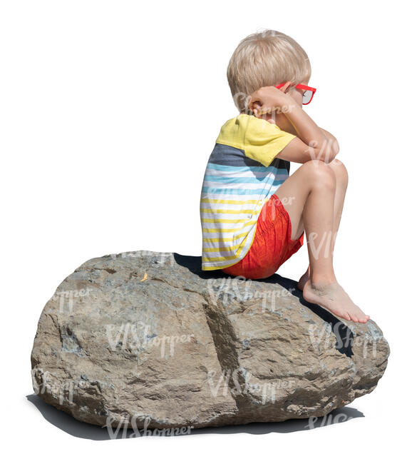 cut out little boy sitting on a big rock