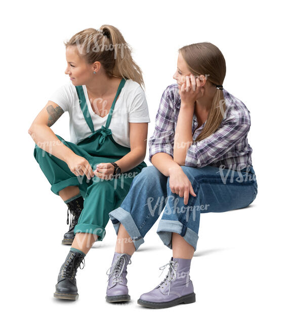 two cut out women sitting on the stairs