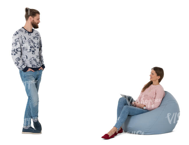 cut out woman sitting in a bean bag talking to a man standing next to her