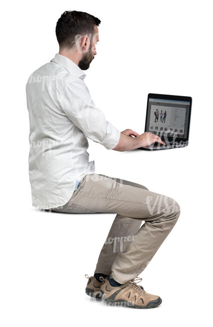 cut out man sitting at a table and working with laptop