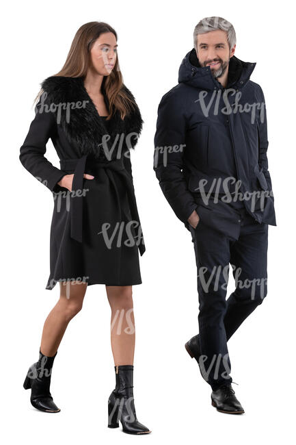 cut out man and woman wearing black overcoats walking