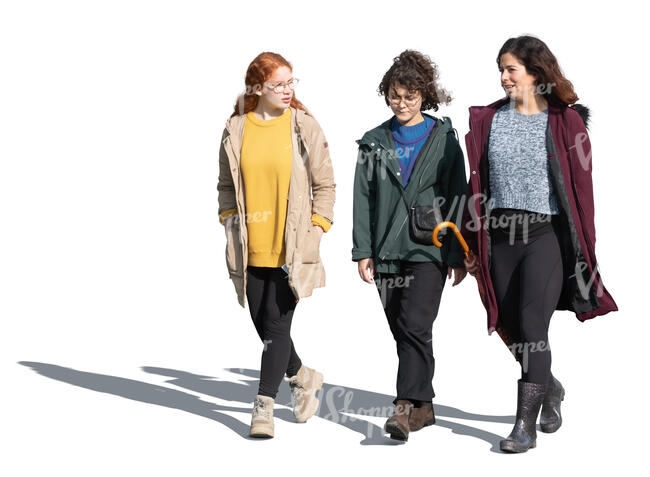 three cut out women walking on sunny autumn day