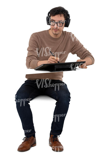 cut out digital artist with headphones sitting and drawing