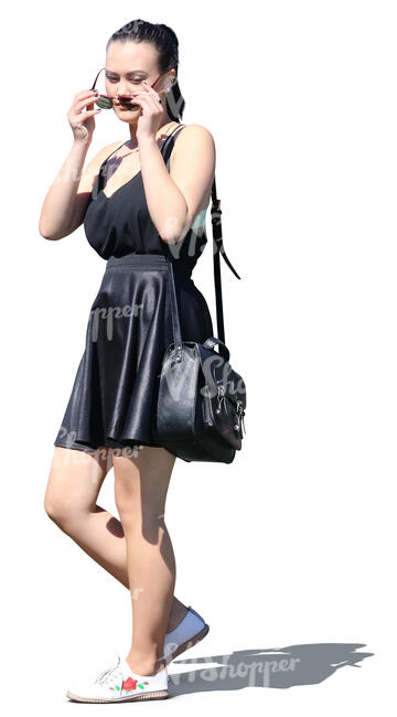 young asian woman in a black summer dress walking