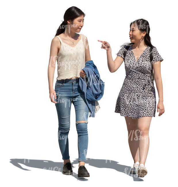 two young asian women walking on a sunny street