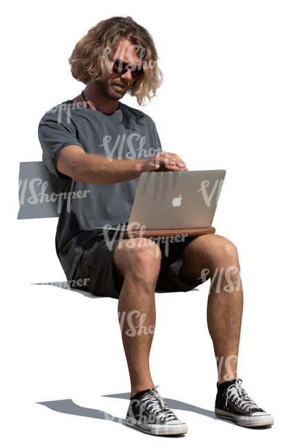 man sitting with a laptop on his knees
