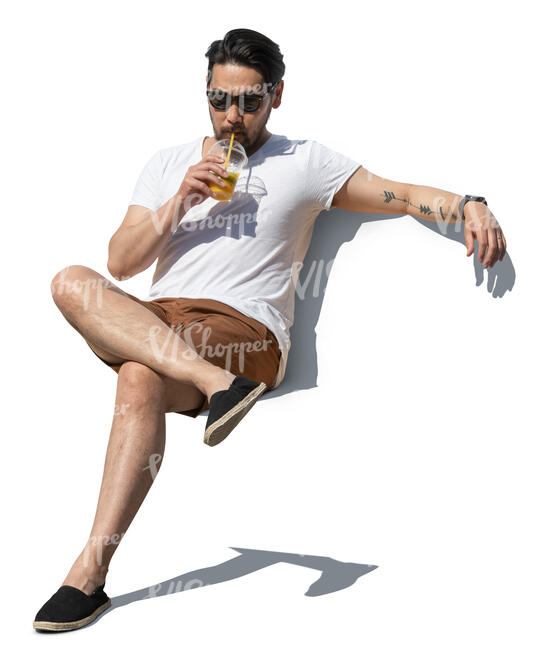 cut out asian man sitting and drinking juice