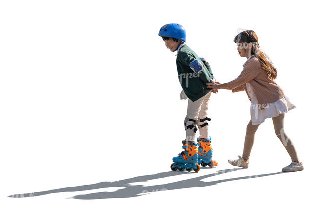 two cut out backlit kids roller skating