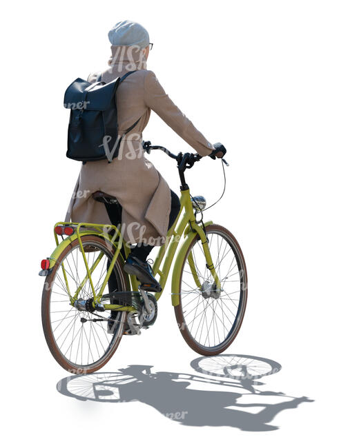 cut out backlit woman in spring overcoat riding a bike