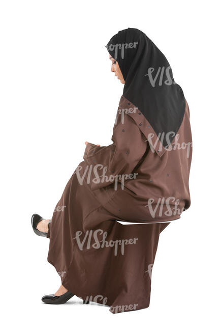 cut out muslim woman in a brown abaya sitting