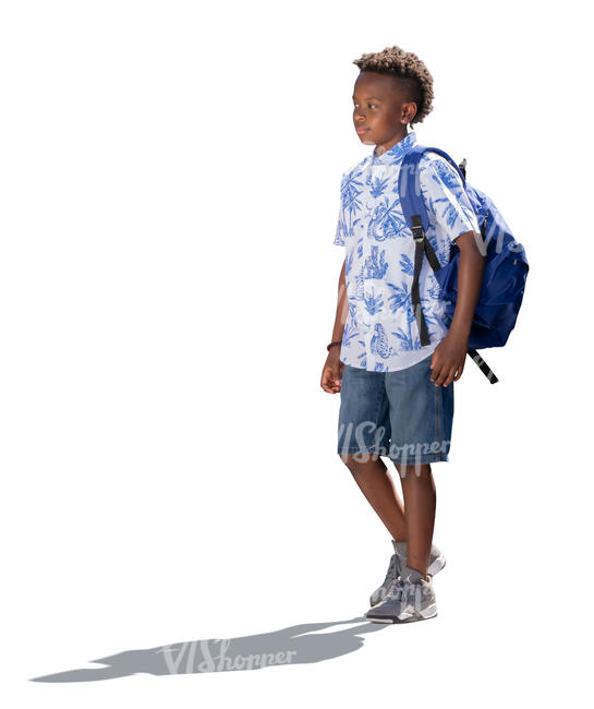 little backlit boy with a backpack walking