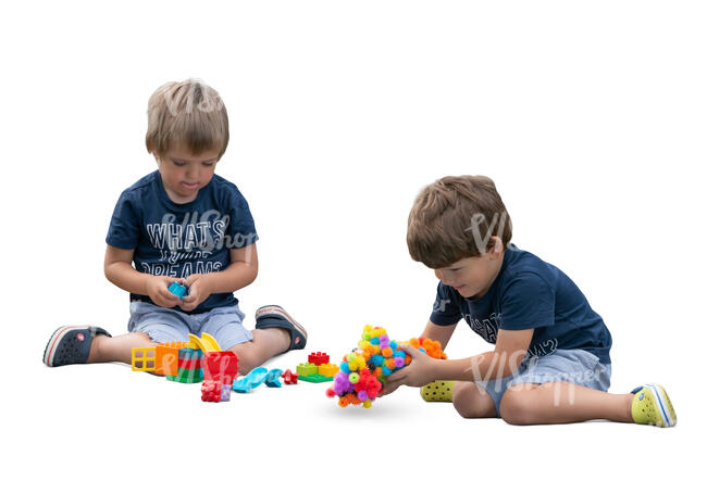 two cut out boys playing with constructor toys