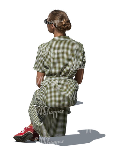 cut out woman in a long green summer dress sitting