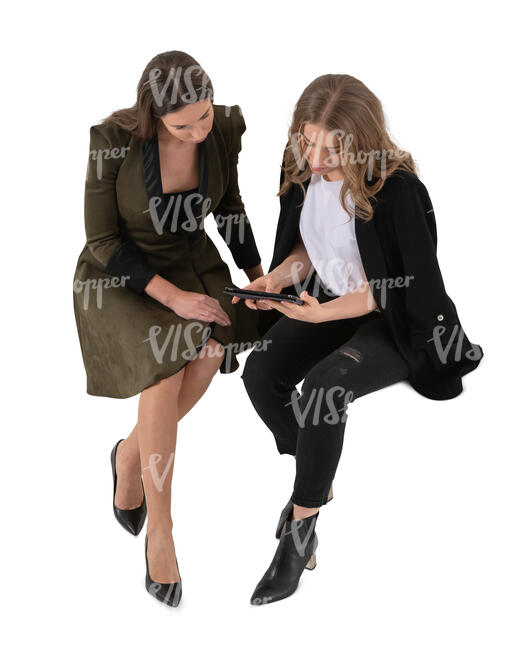 two cut out women sitting seen from above