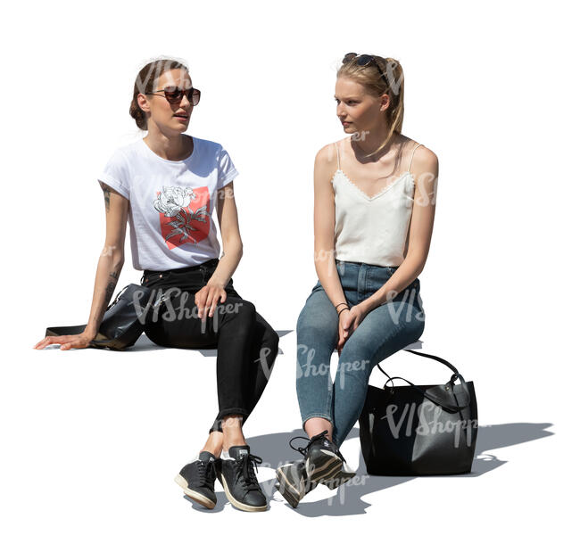 two cut out women sitting outside and talking