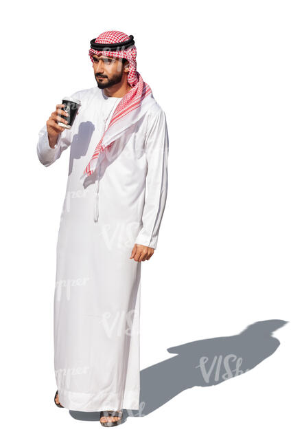 cut ot arab man in traditional emirati clothes standing and drinking coffee