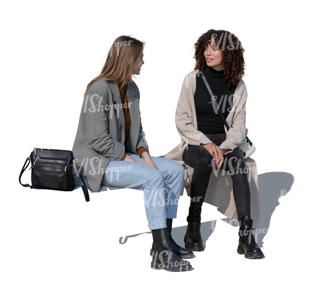 two cut out women sitting and talking