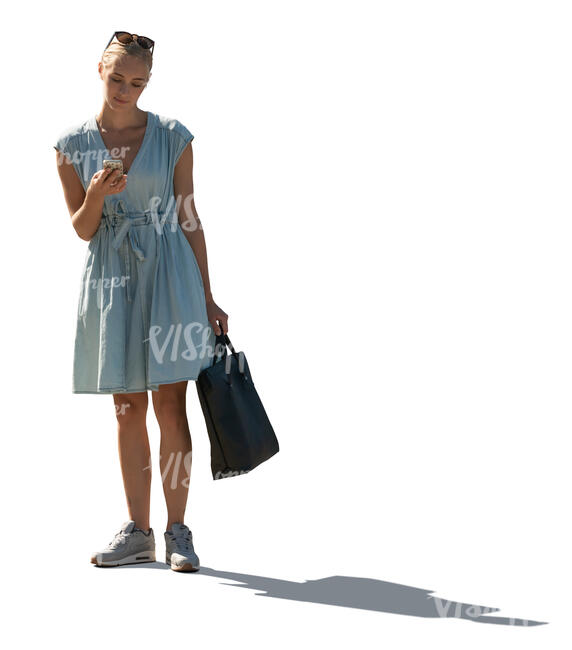 cut out backlit woman in a pale blue summer dress standing