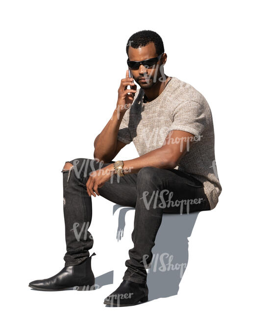 cut out black man sitting and talking on a phone