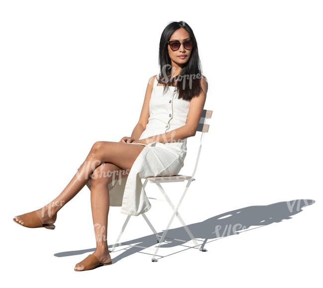 cut out woman in a white summer dress sitting