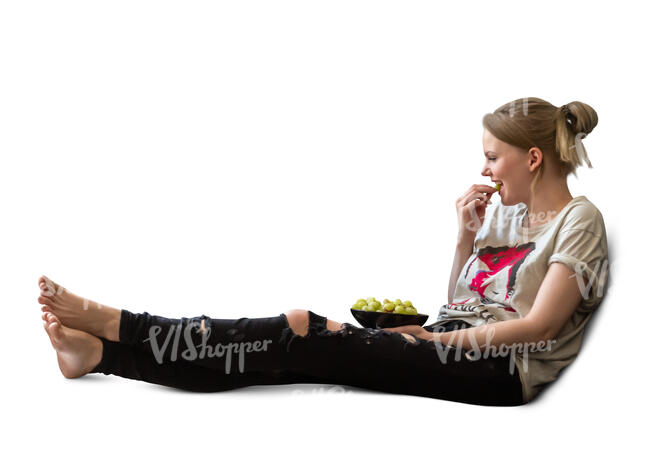 cut out woman sitting on the sofa and eating grapes