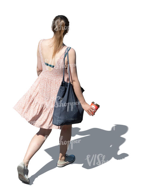 cut out top view of a woman in a pink summer dress walking