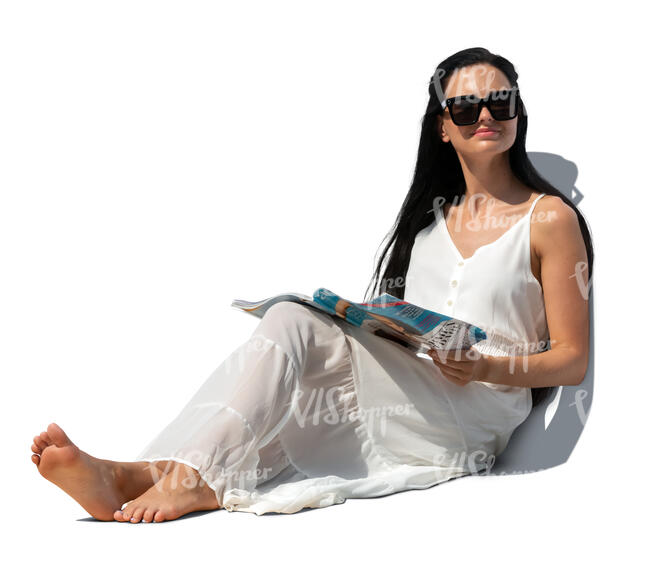 cut out woman in a casual white sitting on a sofa and reading a magazine