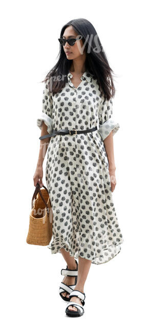 cut out asian woman in a dotted summer dress walking