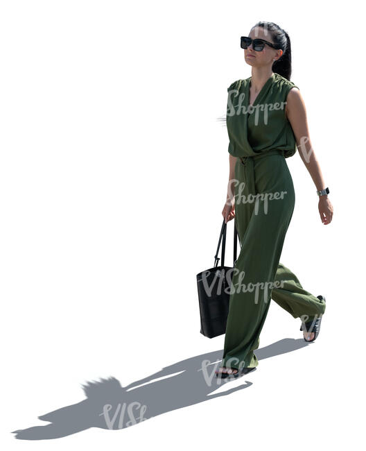 cut out backlit woman in a green jumpsuit walking
