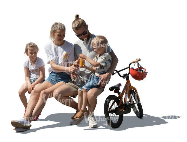 cut out family with two kids sitting on a bench and drinking juice