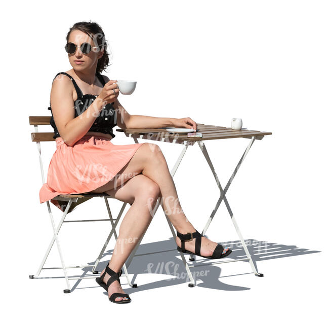 cut out woman sitting at a cafe table and drinking coffee