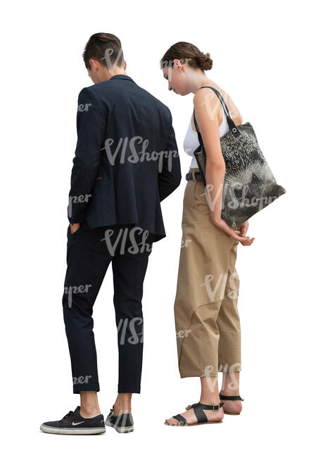 young man and woman standing and looking something on a table