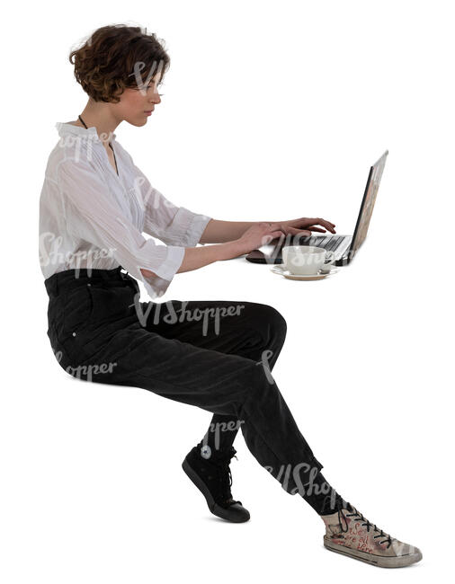 cut out woman sitting at a table with a laptop and drinking coffee