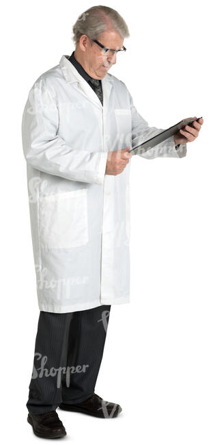 older male doctor standing and reading his notebook