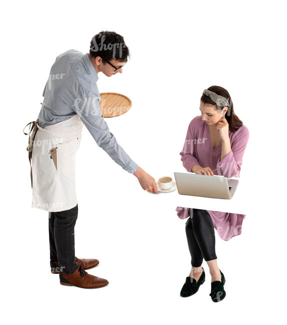 waiter serving coffee to a woman sitting at a table