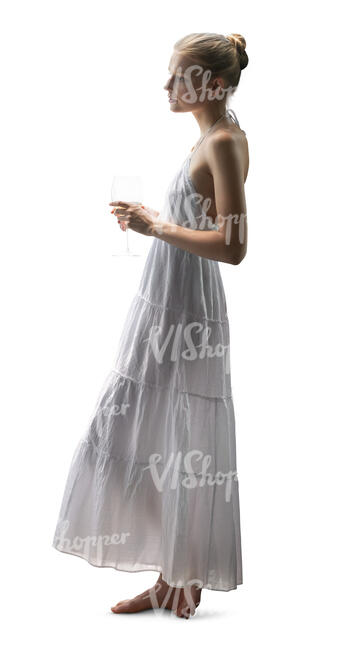 cut out woman in a white dress standing byt the window and drinking wine