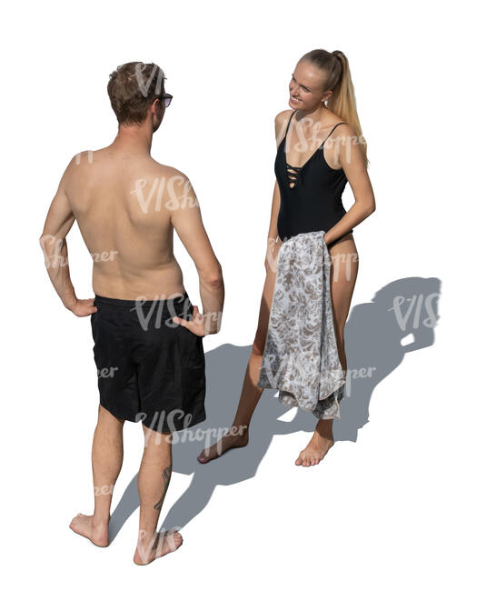 top view of a man and woman at the beach stanfig and talking