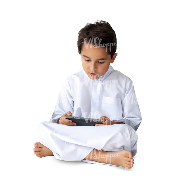 cut out little arab boy sitting and reading from tablet