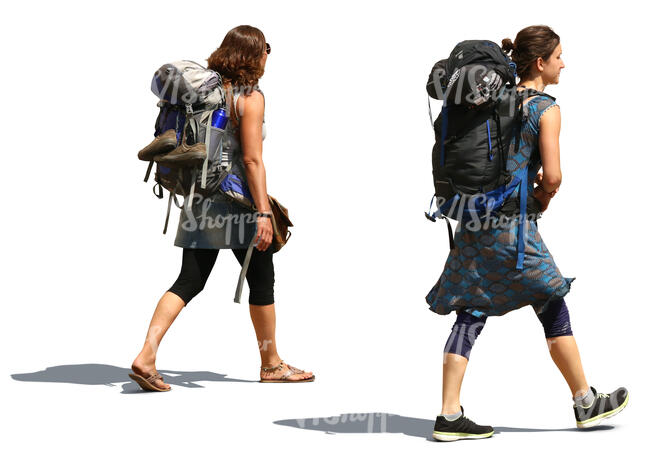 two women with huge backpacks walking on the road