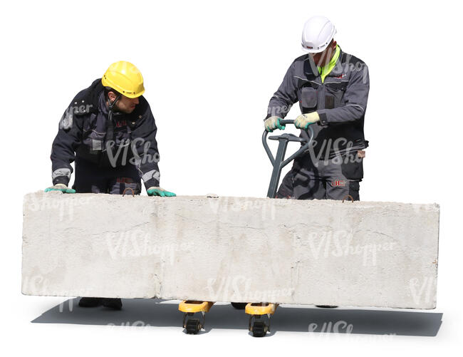 two workers lifting a large concrete block